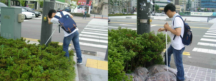 총 2장의 사진 이상훈 팀장이 화단에 설치되어 있는 음향신호기를 찾는 사진