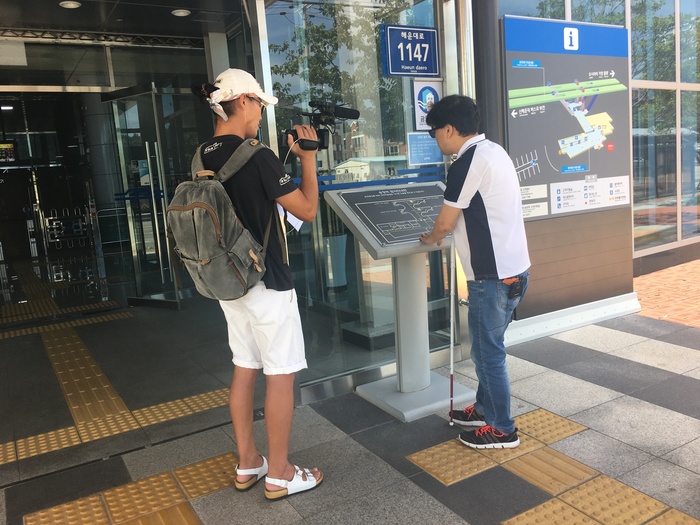 송정역 입구에 설치된 점자촉지도를 조사하고 있는 이상훈 팀장모습