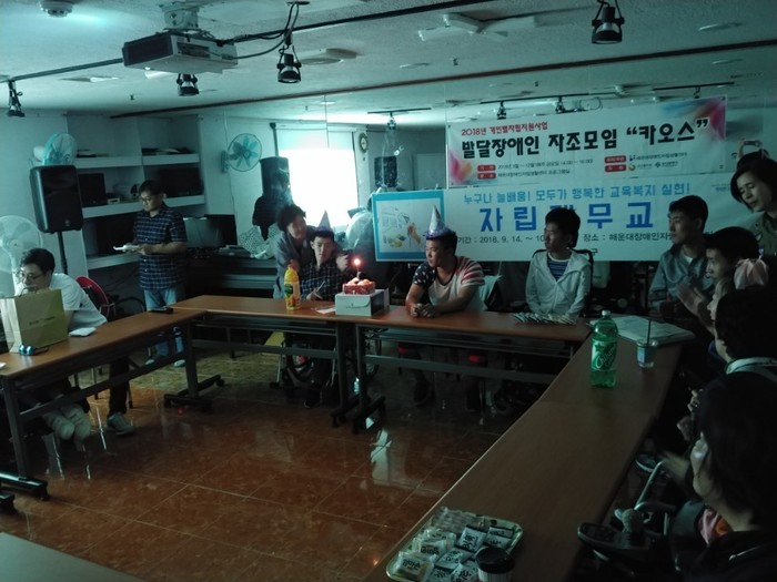 김태우, 반영훈씨가 꼬깔 모자를 쓰고 불켜진케이크를 앞에 친구들이 축하 노래 부르는 사진