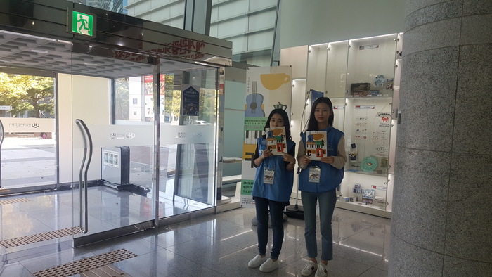 문앞에서 안내를 하는 자원봉사자들 문앞에서 안내를 하는 자원봉사자들