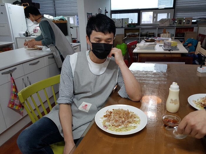 신우씨가 본인이 한 요리 오코노 미야끼를 흐뭇하게 쳐다 보는 사진